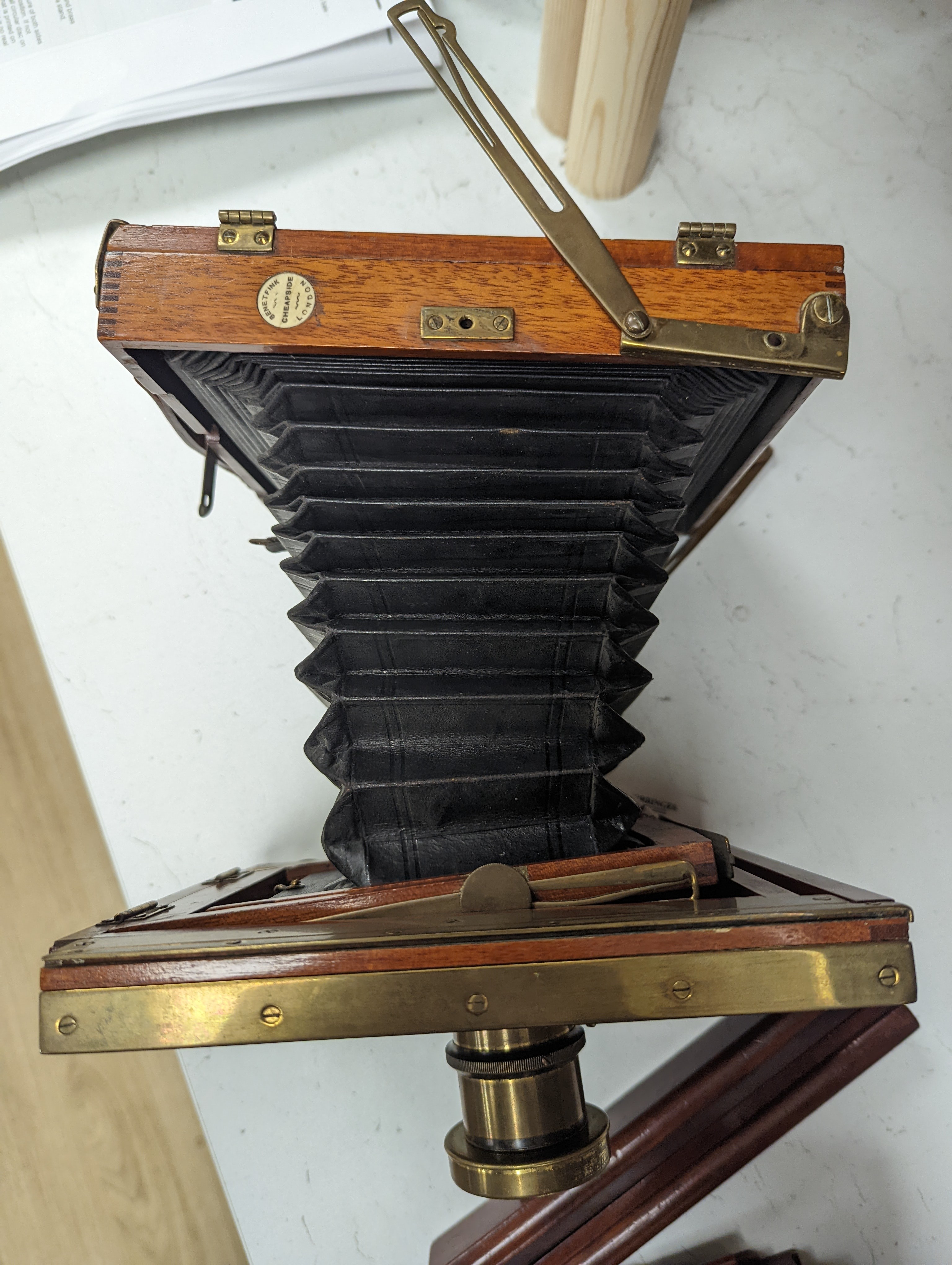 A Thornton Pickard mahogany and brass plate camera, three plates and a stand, 20cm sq.